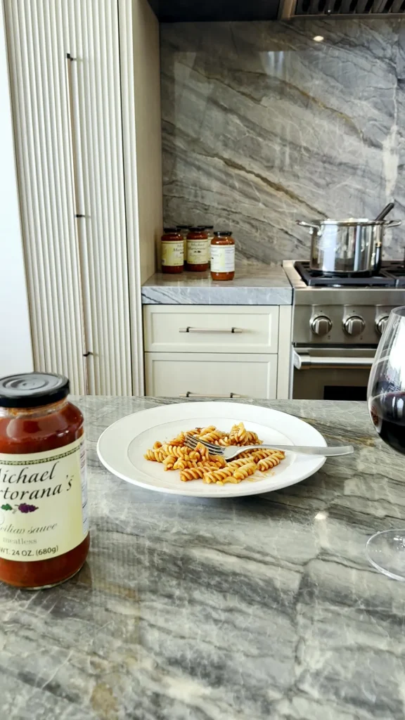 A plate of pasta with Michael's sauce beside the jar